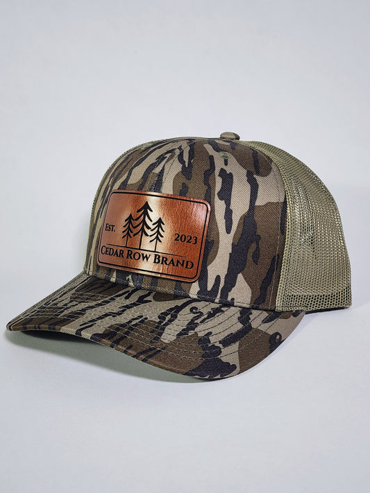 cedar row brand leather patch on a camo trucker hat