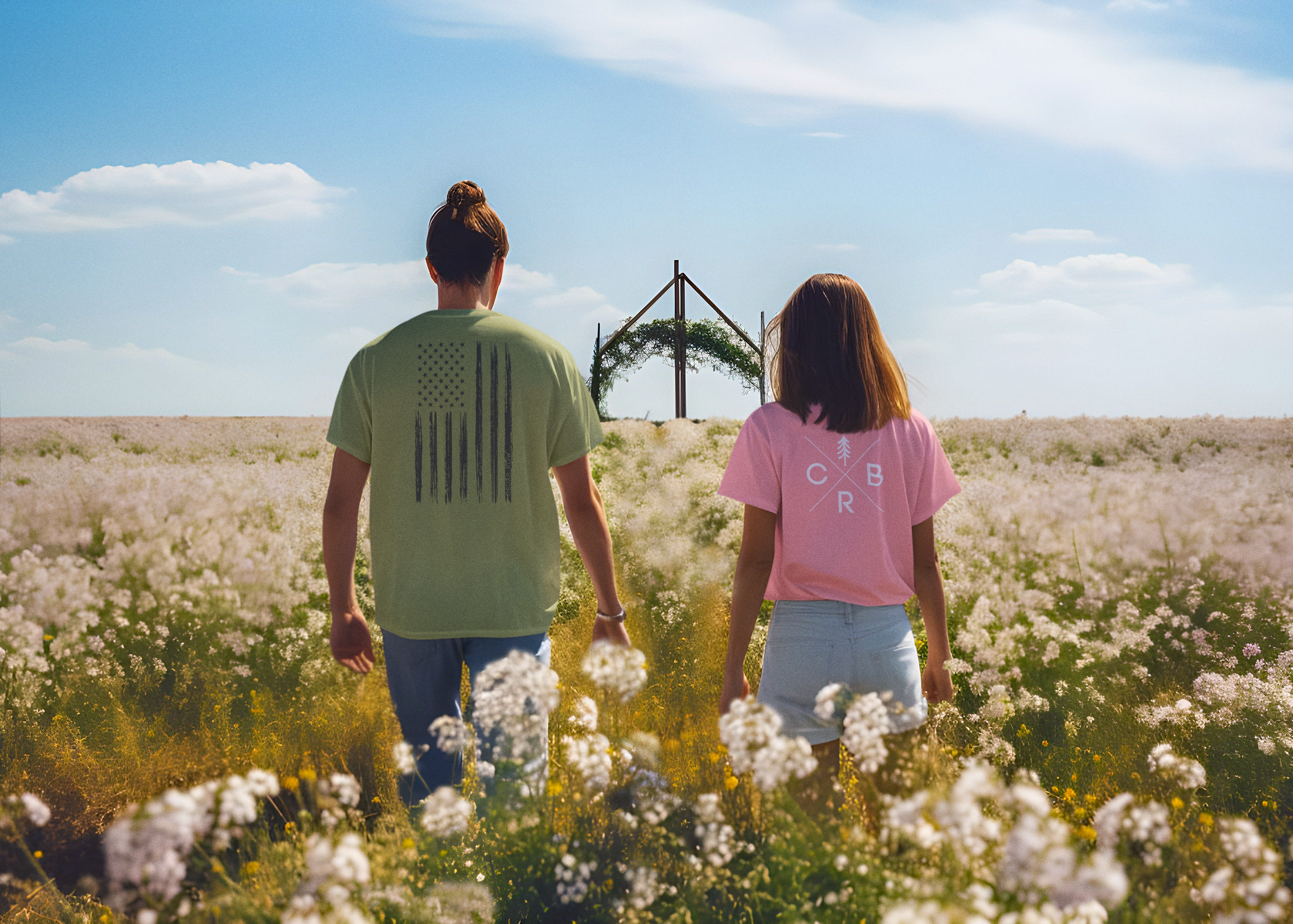 couple wearing patriotic and other southern tshirts in a field